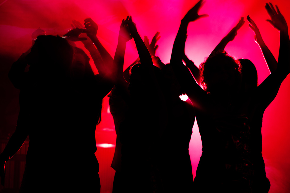 People Dancing in Club with Lightshow